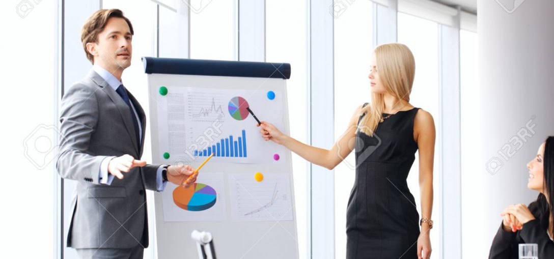 Business meeting Workers at business meeting looking at presentation of financial reports in modern office